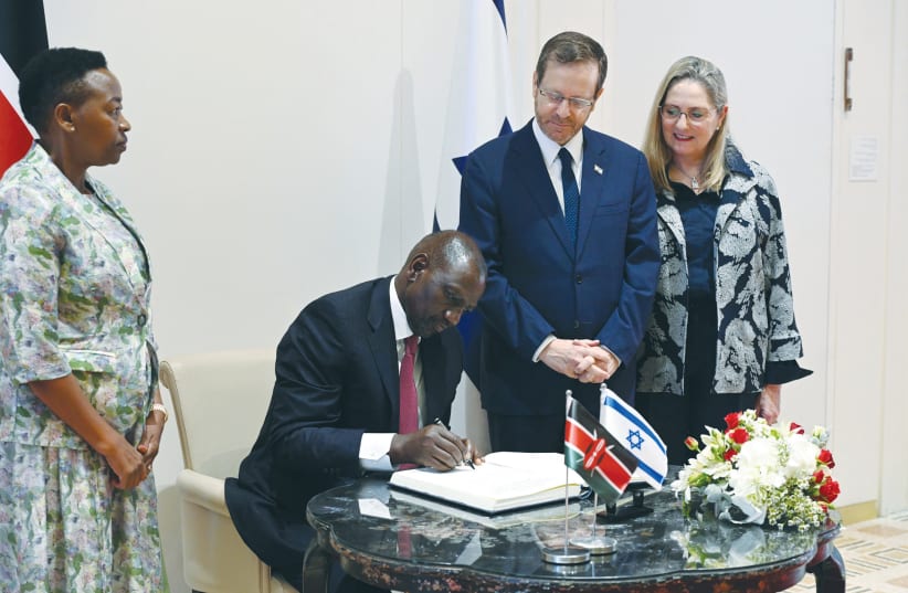  PRESIDENT WILLIAM RUTO of Kenya signs the guest book at the President’s Residence while his wife, Rachel, and President Isaac Herzog and his wife, Michal, look on.  (photo credit: HAIM ZACH/GPO)