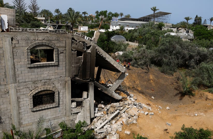 A view of a damaged building on the site of an Israeli airstrike amid Israel-Gaza fighting in Deir al-Balah town in the central Gaza Strip, May 12, 2023 (photo credit: REUTERS/IBRAHEEM ABU MUSTAFA)