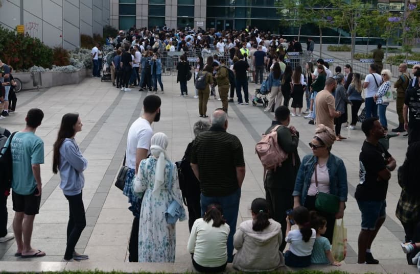  People queue up at the temporary appointment-free passport office in Tel Aviv the day it opens. (photo credit: AVSHALOM SASSONI/MAARIV)