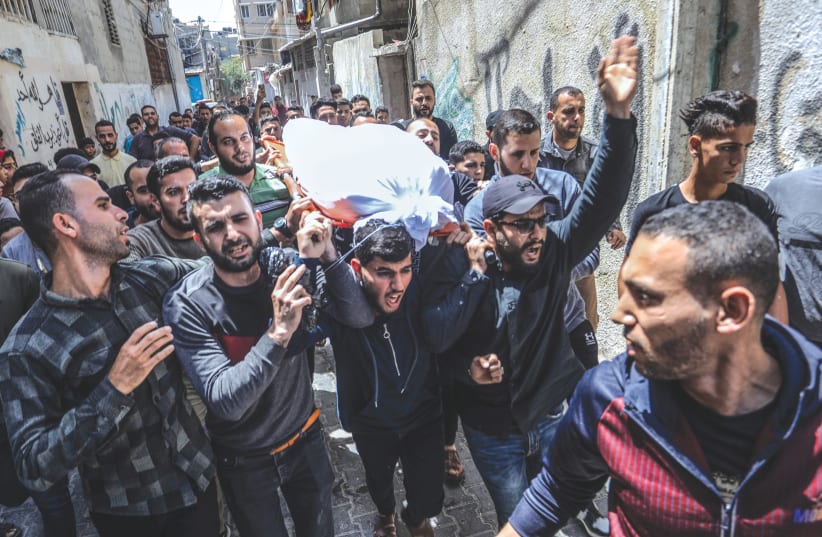  A FUNERAL procession takes place for Islamic Jihad commander Ali Ghali and his brother, Mahmoud, who were killed in an Israeli strike in Khan Yunis, Gaza Strip, on Thursday. (photo credit: ABED RAHIM KHATIB/FLASH90)