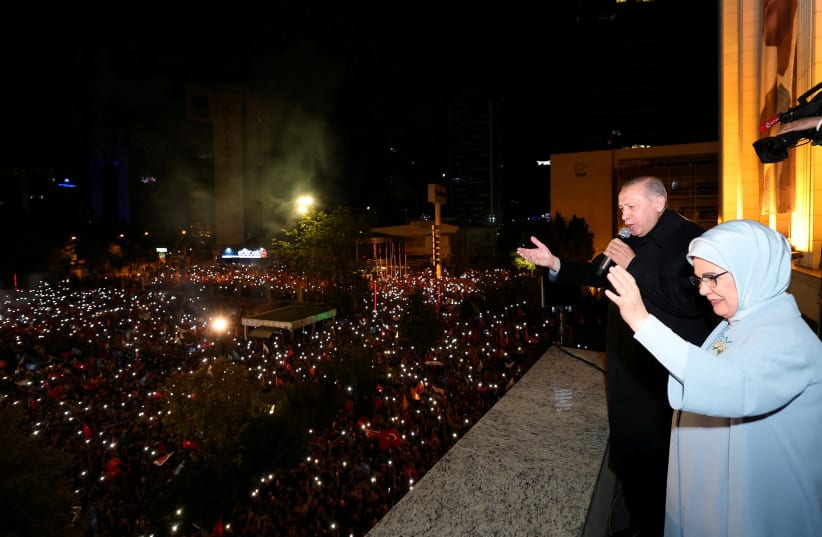  Turkish President Tayyip Erdogan, accompanied by his wife Emine Erdogan, addresses his supporters at the AK Party headquarters in Ankara, Turkey May 15, 2023. (photo credit: PRESIDENTIAL PRESS OFFICE/HANDOUT VIA REUTERS)