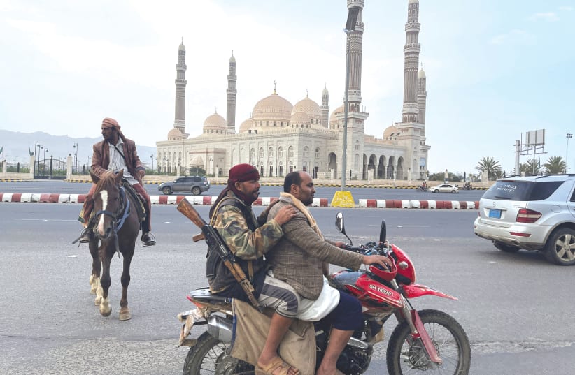  ARMED MEN ride on a motorbike  in Sanaa, the capital of Yemen,  as Saudi and Omani delegations  hold talks with the Houthis last month. (photo credit: REUTERS/KHALED ABDULLAH)