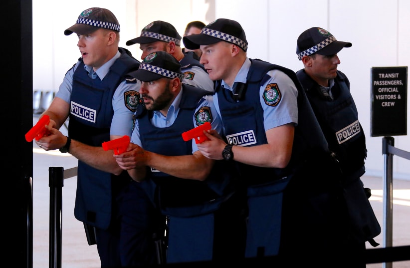Australian police officers participate in a training scenario called an 'Armed Offender/Emergency Exercise' at an international passenger terminal at Sydney Harbour in Australia, July 27, 2017 (photo credit: REUTERS/DAVID GRAY)
