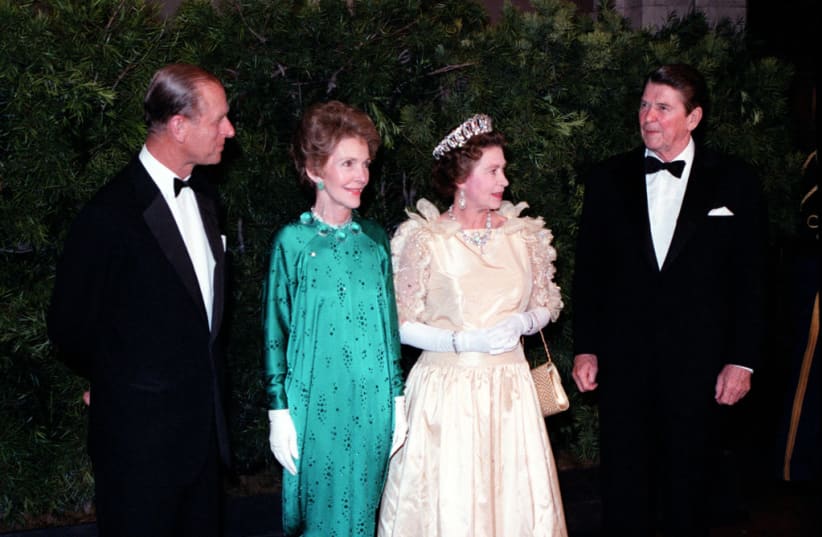  Queen Elizabeth II and Prince Philip stand with President and Mrs. Reagan at a state dinner during her 1983 visit to the US. (photo credit: GetArchive)