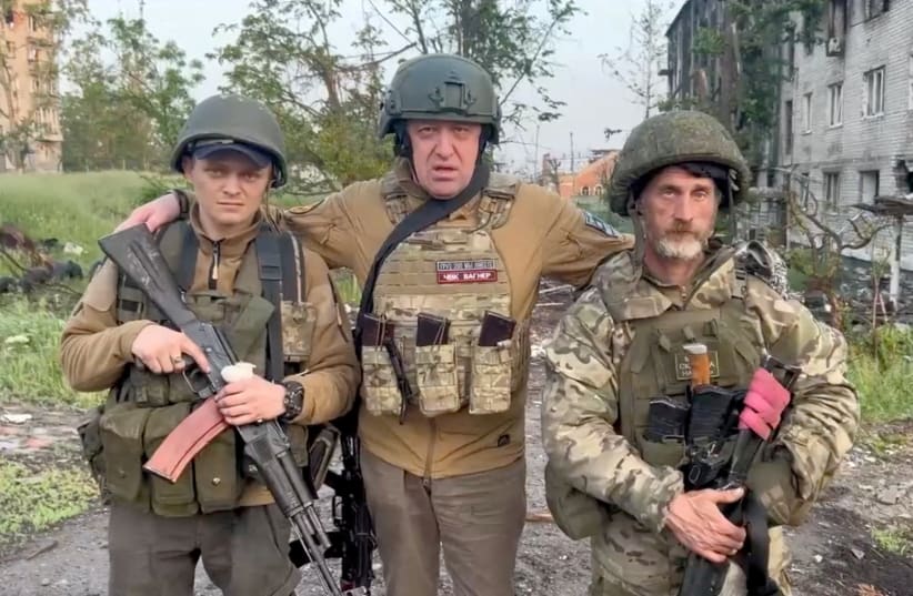  Founder of Wagner private mercenary group Yevgeny Prigozhin poses with mercenaries "Biber" and "Dolik" during a statement on the start of withdrawal of his forces from Bakhmut and handing over their positions to regular Russian troops, on May 25, 2023. (photo credit: PRESS SERVICE OF "CONCORD"/HANDOUT VIA REUTERS)