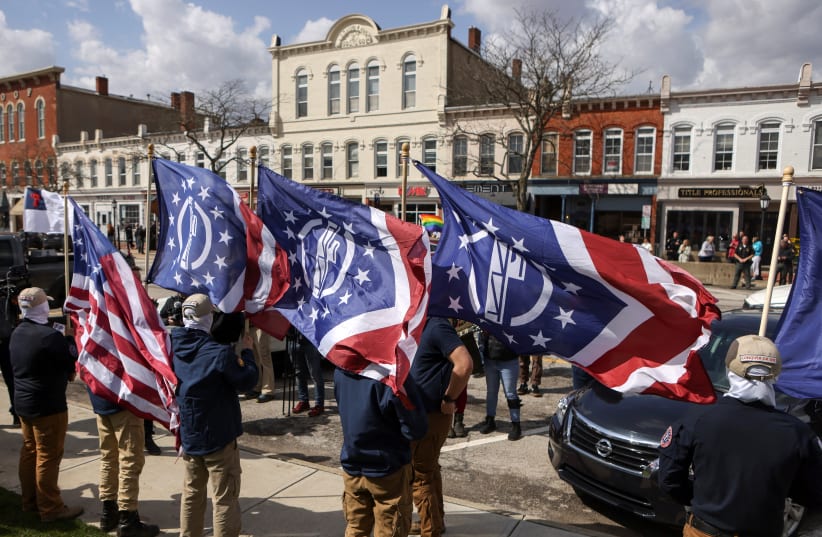Members of the white nationalist group Patriot Front protest drag show brunch fundraiser ahead of a Drag Show Story Hour in Chardon, Ohio, U.S., April 1, 2023.  (photo credit: JIM URQUHART/REUTERS)