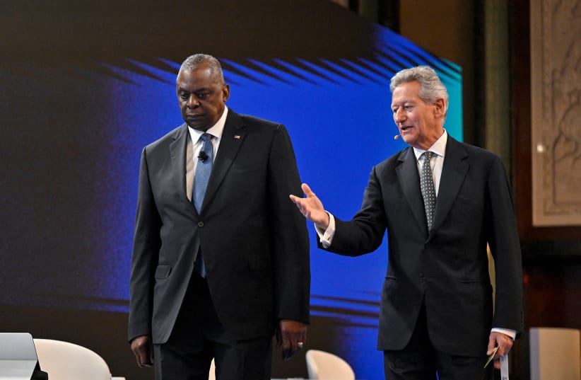  IISS Director-General and Chief Executive John Chipman leads U.S. Secretary of Defense Lloyd Austin to his seat at the First Plenary Session of the 20th IISS Shangri-La Dialogue in Singapore June 3, 2023. (photo credit: CAROLINE CHIA/REUTERS)