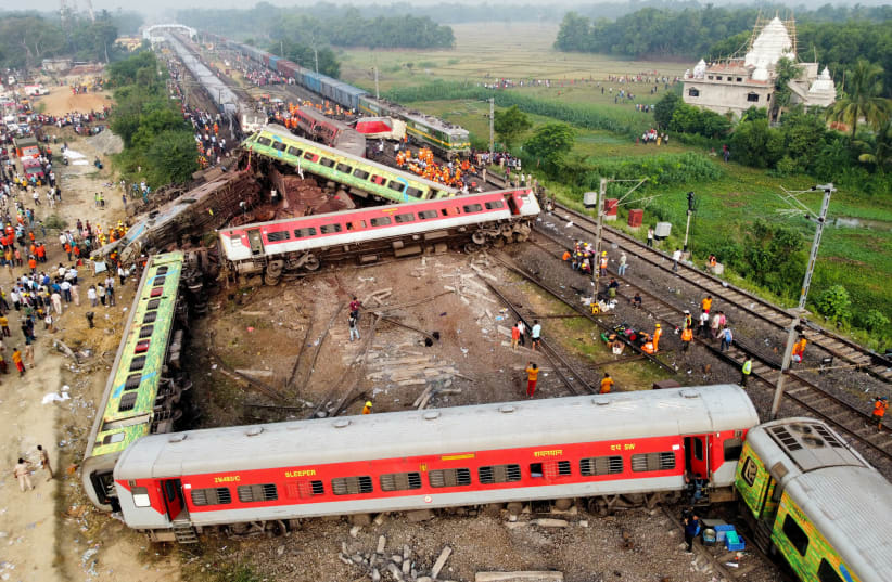  A drone view shows derailed coaches after two passenger trains collided in Balasore district in the eastern state of Odisha, India, June 3, 2023. (photo credit: REUTERS/STRINGER)