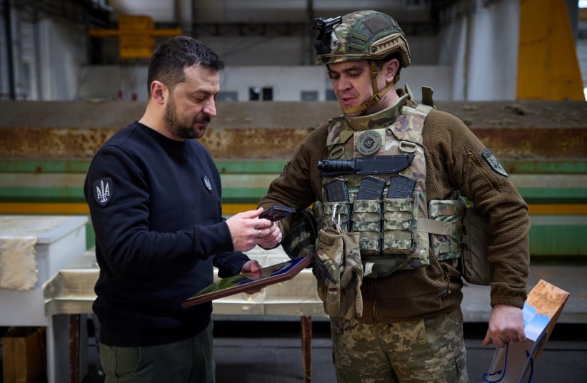  Ukraine's President Volodymyr Zelensky receives a military patch from a Ukrainian service member during his visit at a frontline, amid Russia's attack on Ukraine, in Avdiivka, Donetsk region, Ukraine April 18, 2023. (photo credit: Ukrainian Presidential Press Service/Handout via REUTERS)