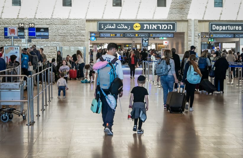  Travelers are seen at the departure hall of the Ben Gurion International Airport on April 4, 2023 (photo credit: AVSHALOM SASSONI/FLASH90)
