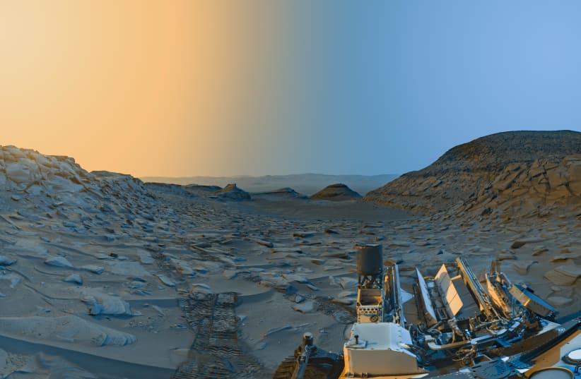 NASA’s Curiosity Mars rover used its black-and-white navigation cameras to capture panoramas of “Marker Band Valley” at two times of day on April 8. Color was added to a combination of both panoramas for an artistic interpretation of the scene. (photo credit: NASA/JPL-Caltech)