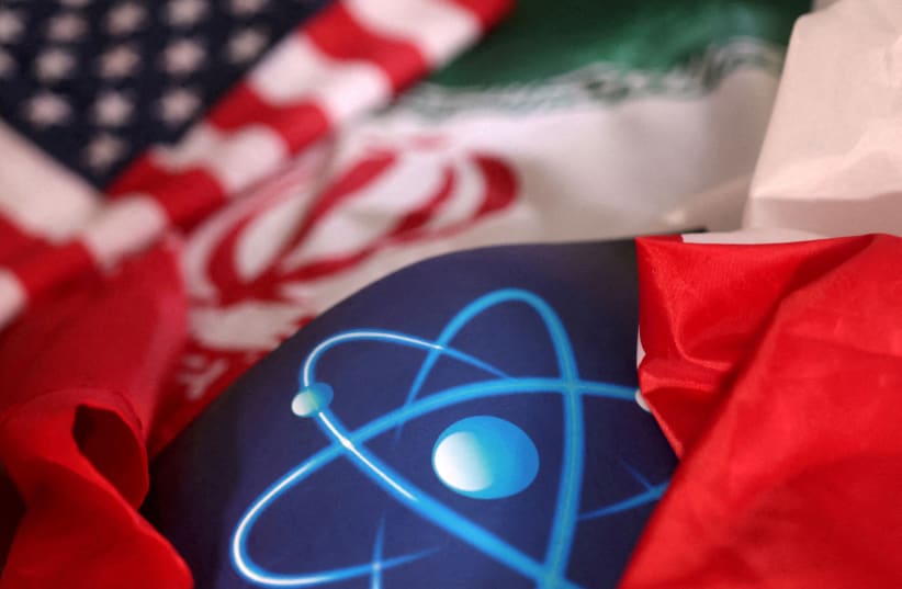  Atomic symbol and USA and Iranian flags are seen in this illustration taken, September 8, 2022. (photo credit: DADO RUVIC/REUTERS ILLUSTRATION)