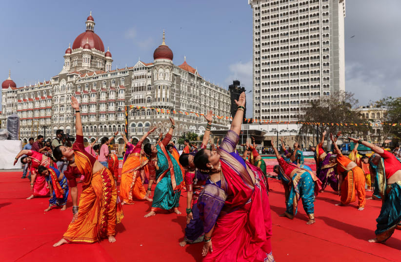  People perform yoga in front of Taj Hotel, during International Yoga Day in Mumbai, India, June 21, 2023. (photo credit: Francis Mascarenhas)