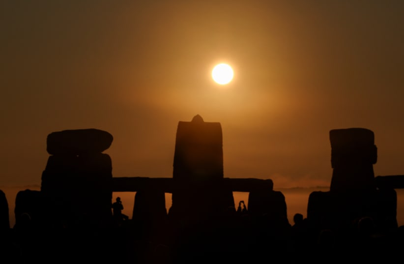  Revellers attend summer solstice celebrations at Stonehenge near Amesbury, Britain, June 21, 2023. (photo credit: TOBY MELVILLE/REUTERS)