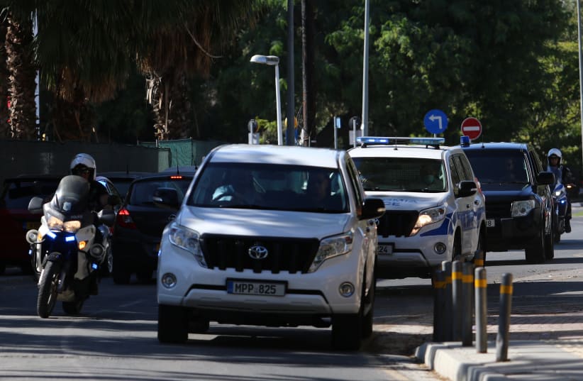  Police vehicles arrive at a court, where a remand order was issued against a man suspected of plotting to murder Israeli businesspeople on the island, in Nicosia, Cyprus October 6, 2021. (photo credit: REUTERS/YIANNIS KOURTOGLOU)