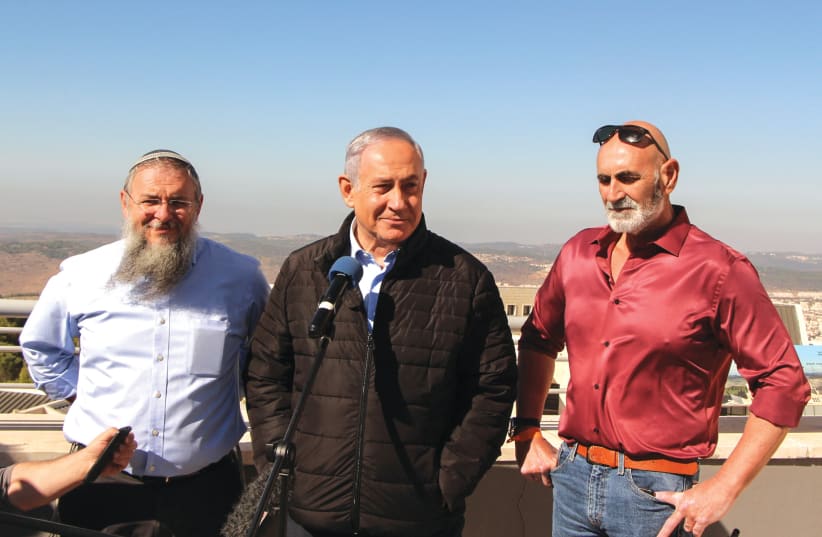  PRIME MINISTER Benjamin Netanyahu is flanked by the writer (left) and Jordan Valley Regional Council head David Elhayani, in 2019. (photo credit: GERSHON ELINSON/FLASH90)