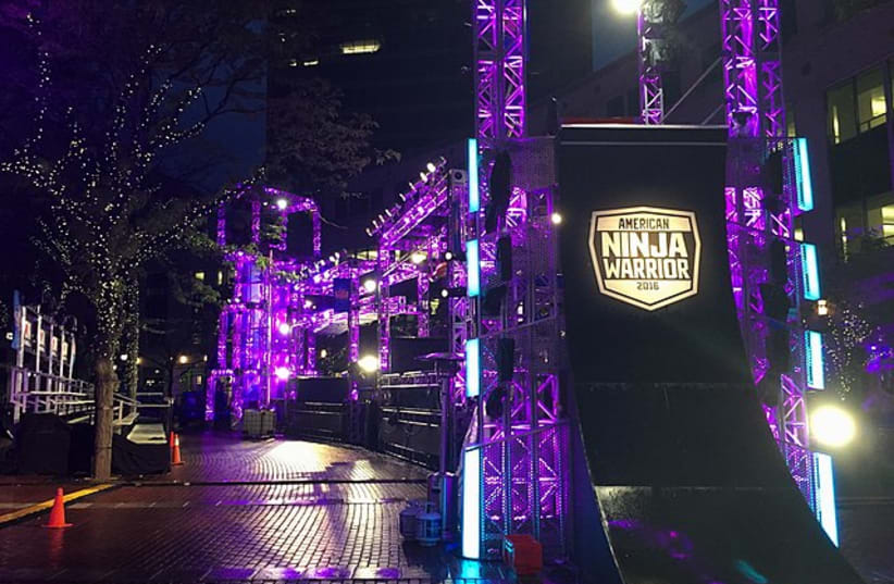  The iconic Warped Wall and the second part of the course, used for City Finals, at Indianapolis during American Ninja Warrior season 8. Located at Monument Circle, this was the first time ever that the course was built in a curve. (photo credit: Wikimedia Commons)
