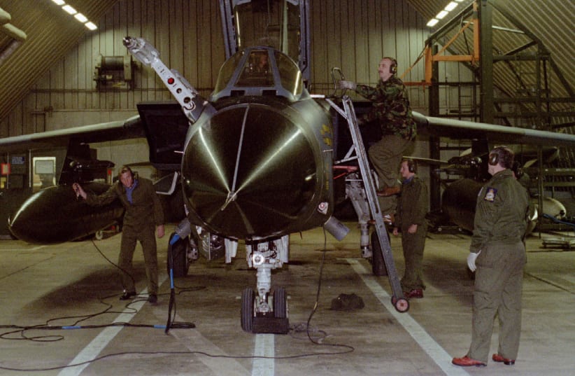 Technical personnel prepare one of six British Tornado fighters October 11 before the planes took off from the Royal Air Force base in Brueggen (photo credit: REUTERS)