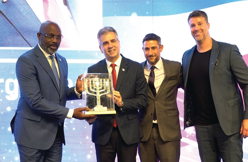  LIBERIAN PRESIDENT George Weah receives the Friends of Zion award from Foreign Minister Eli Cohen at the Friends of Zion Museum in Jerusalem, while FOZ President Michael Evans (far right) and Nir Kimhi, chairman of the FOZ Board of Directors, look on.  (photo credit: DOTAN GUETA)