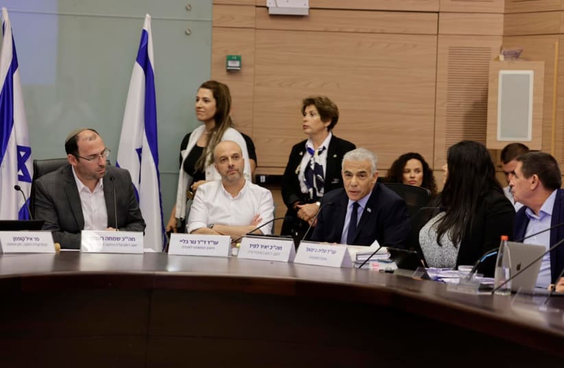  Israeli lawmakers such as MK Simcha Rothman (L) and opposition leader MK Yair Lapid (R) are seen at a meeting of the Knesset Constitution, Law, and Justice Committee amid debates surrounding the reasonableness standard and mass protests against judicial reform, in Jerusalem, on July 11, 2023. (photo credit: MARC ISRAEL SELLEM/THE JERUSALEM POST)