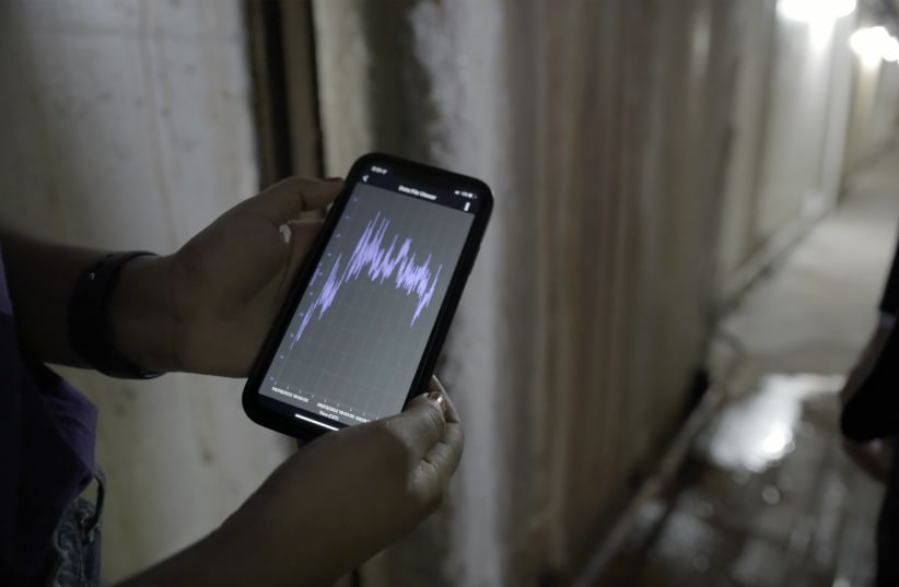  A  smartphone receives data from the underground temperature sensors (photo credit: Northwestern University)