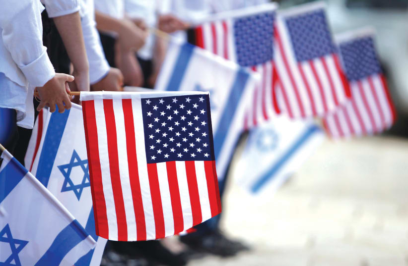  JERUSALEM SCHOOLCHILDREN hold Israeli and American flags during a rehearsal for former US President Barack Obama’s visit to Israel in 2013. (photo credit: BAZ RATNER/REUTERS)