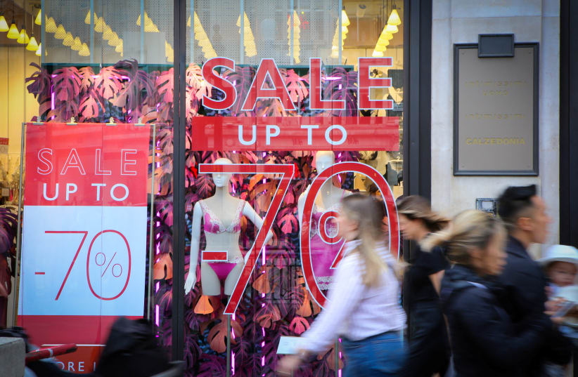  Shoppers walk past sale signs on Oxford Street, as Britain struggles with the highest inflation rate among the world's big rich economies, London, Britain, 17 July 2023 (photo credit: REUTERS/RACHEL ADAMS)