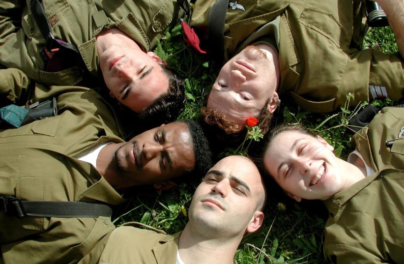  IDF soldiers laying on grass. (photo credit: Wikimedia Commons)