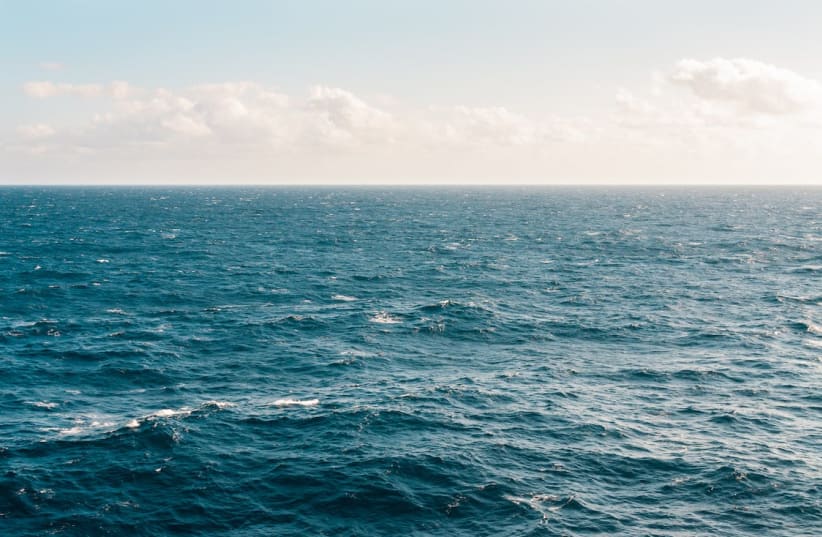  The calm surface of the ocean on a clear day. (photo credit: PEXELS)