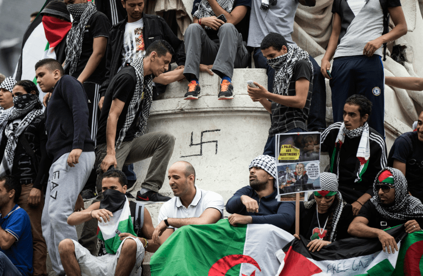  The base of the Statue de la République in Paris is defaced with a swastika as a protest in support of Palestinians turns anti-Semitic, July 26, 2014.  (photo credit: Etienne Laurent/EPA/Corbis)