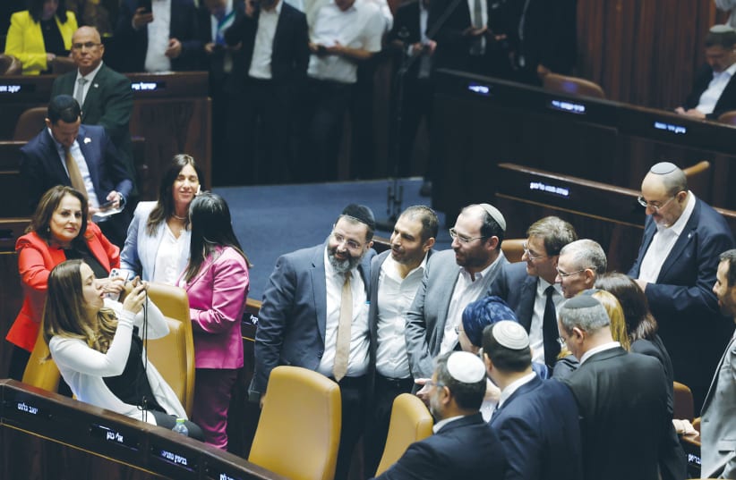  GOVERNMENT COALITION members celebrate in the Knesset plenum with a photograph after passage of the amendment to the Basic Law: The Judiciary, on Monday. (photo credit: Marc Israel Sellem/Jerusalem Post)
