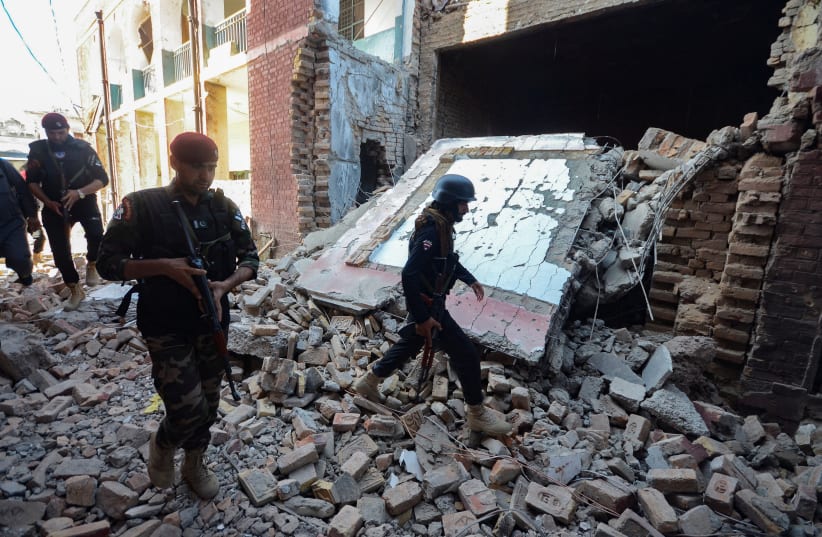  Police officers walk amid the rubble of a damaged building, after a suicide blast in Bara, on the outskirts of Peshawar, Pakistan July 20, 2023. (photo credit: REUTERS/STRINGER)