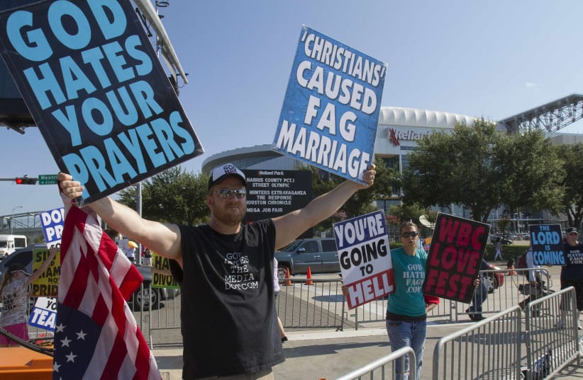  Members of the Westboro Baptist Church of Topeka, Kansas, protest outside the venue of "The Response", an event billed by its organizer, Texas Governor Rick Perry, as a call to prayer for a nation in crisis, at the Reliant stadium in Houston August 6, 2011.  (photo credit: REUTERS/RICHARD CARSON)