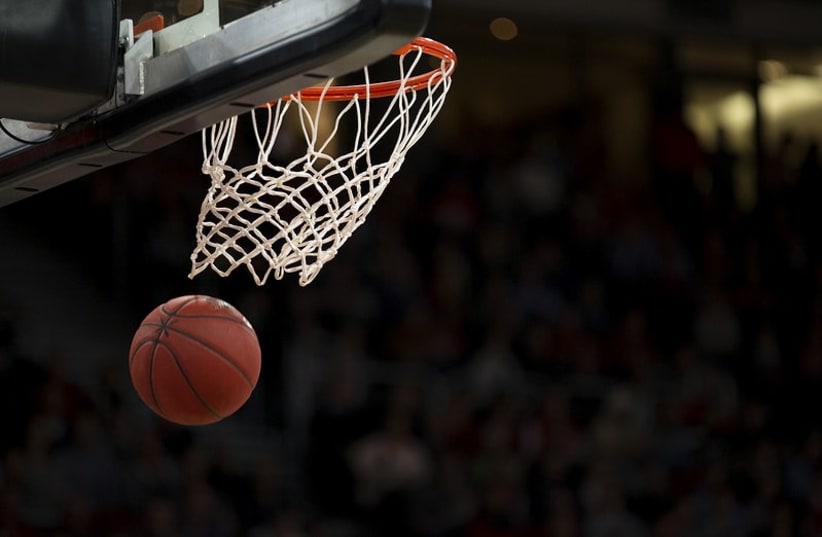  A basketball passing through a hoop. (photo credit: Yahoo Sports)