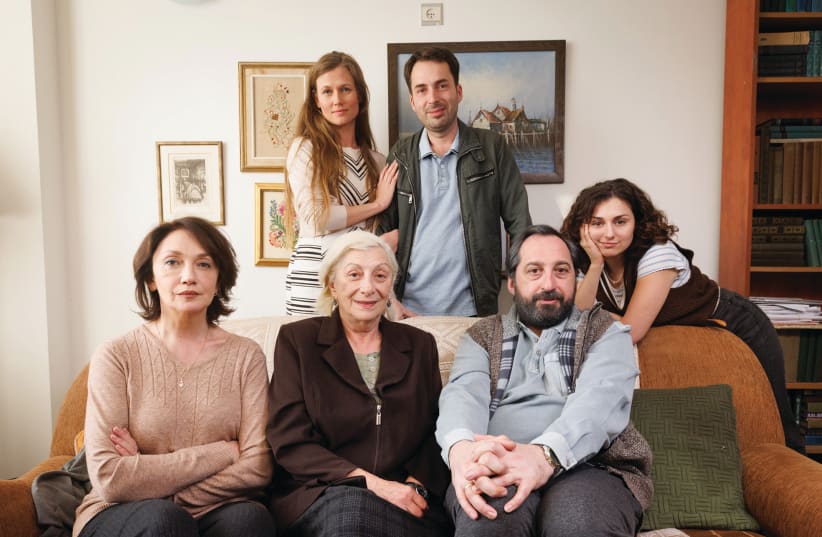  ‘SOVIETZKA’ (Sitting, from left) Evgenia Dodina as the mother, Fira Kantor as the grandmother, and Gera Sandler as the father. (Standing, from left) Lena Fraifeld, Daniel Styopin and Suzanna Papian. (photo credit: Micha Brikman/KAN 11)