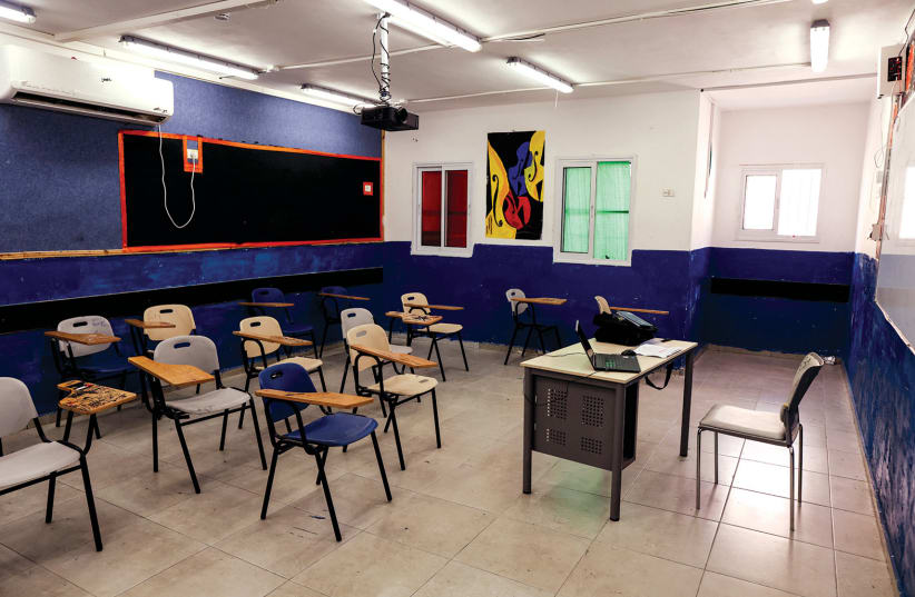  AN EMPTY classroom in an east Jerusalem school, closed in protest at ‘Israeli censorship’ of PA-autorized school textbooks, last year.  (photo credit: AMMAR AWAD/REUTERS)