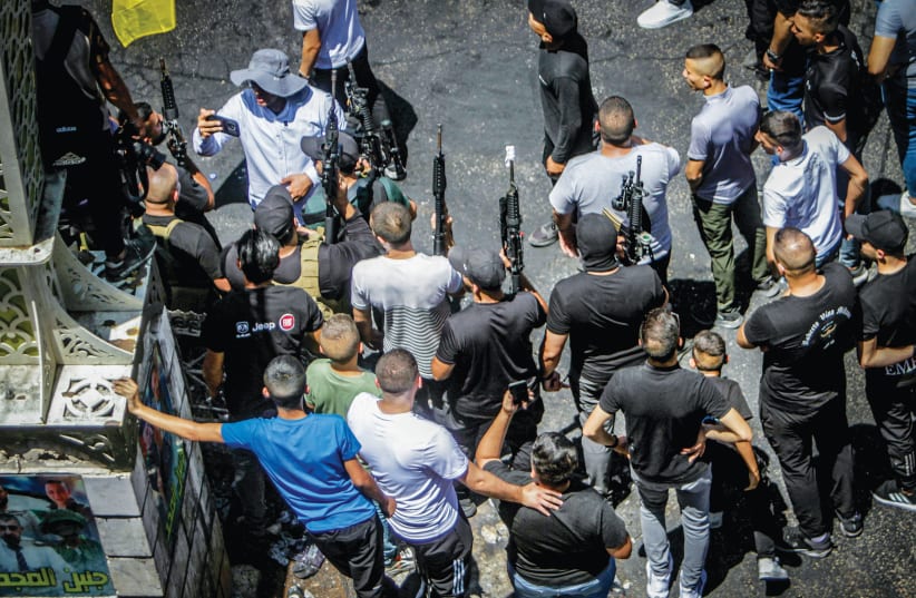  ARMED PALESTINIANS march after an Israeli military operation in Jenin last month.  (photo credit: NASSER ISHTAYEH/FLASH90)