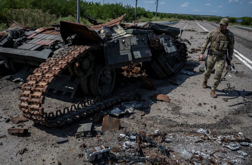  A Ukrainian serviceman walks near a destroyed Ukrainian tank, as Russia's attack on Ukraine continues, near the village of Robotyne, Zaporizhzhia region, Ukraine August 25, 2023.  (photo credit: REUTERS/Viacheslav Ratynskyi)