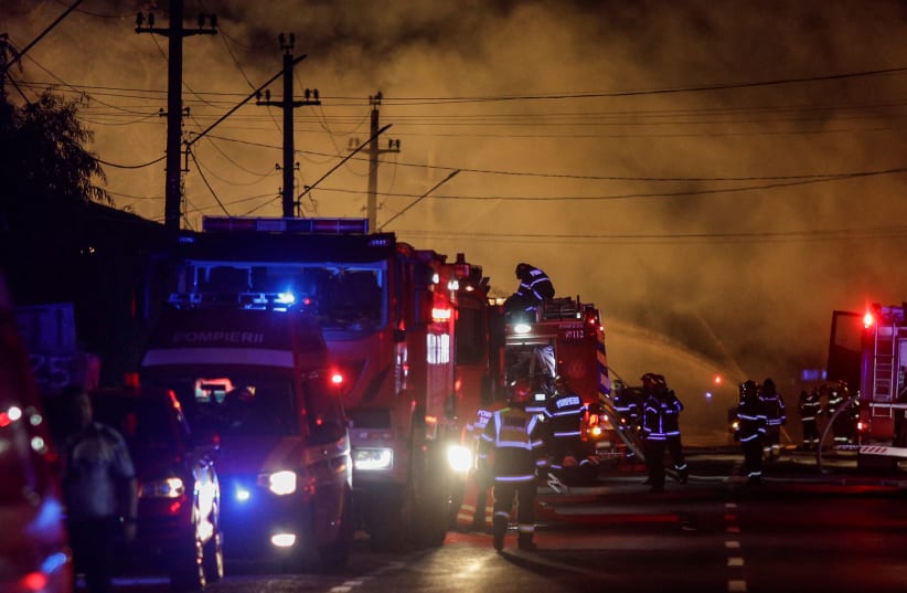  Fire fighters work as flames rise after an explosion at a LPG station in Crevedia, near Bucharest, Romania, August 26, 2023. (photo credit: Inquam Photos/Octav Ganea via REUTERS)