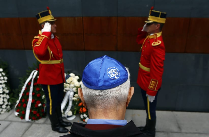 A member of Romania's Jewish community lays a wreath during ceremonies at a Holocaust memorial in Bucharest October 8, 2014 (photo credit: REUTERS/BOGDAN CRISTEL)
