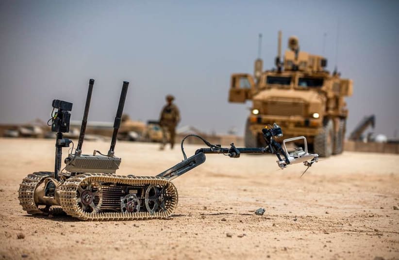  A TALON tracked military robot picks up a downed unmanned aerial system at Al Asad Air Base, Iraq, May 19, 2020. (U.S. Army photo by Spc. Derek Mustard) (photo credit: PICRYL)