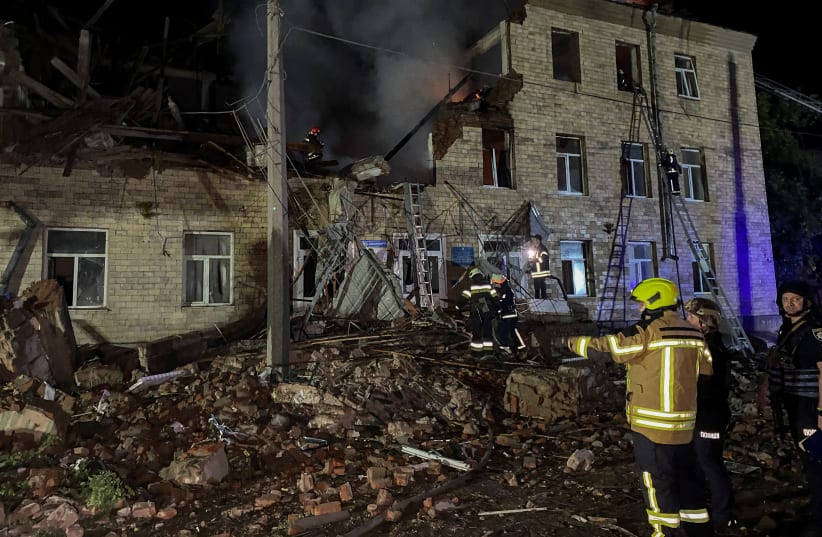  Rescuers work at a site of a building damaged by a Russian drone strike, amid Russia's attack on Ukraine, in Kharkiv, Ukraine August 1, 2023. (photo credit: REUTERS/Vitalii Hnidyi)