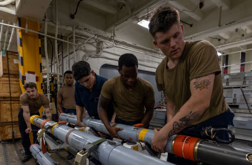  The amphibious assault ship USS Bataan's (LHD-5) Weapons Department Sailors assemble a missile, while under the command and control of Task Force 51/5 on a scheduled deployment to the U.S. 5th Fleet area of operations to help ensure maritime security and stability in the Middle East region. (photo credit: US NAVAL FORCES CENTRAL COMMAND/US 5TH FLEET/HANDOUT VIA REUTERS)