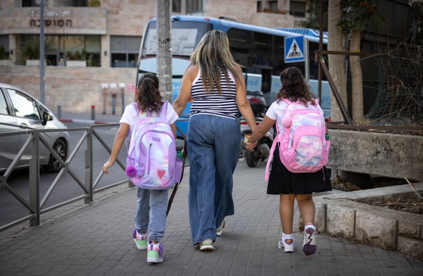  Young Israeli students arrive for their first day of school, at a school in Jerusalem, September 1, 2023. (photo credit: Chaim Goldberg/Flash90)