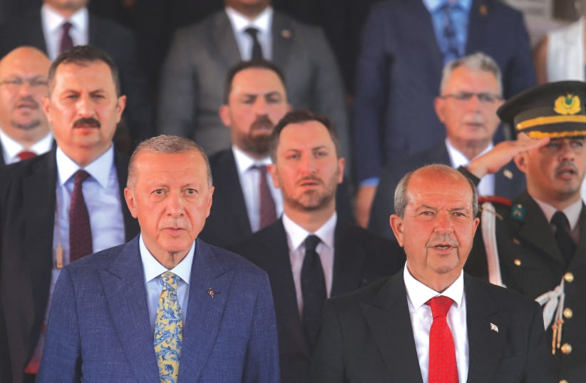  TURKISH PRESIDENT Tayyip Erdogan and Turkish Cypriot leader Ersin Tatar attend a military parade in the divided city of Nicosia, in July, to mark the anniversary of the 1974 Turkish invasion of Cyprus.  (photo credit: YIANNIS KOURTOGLOU/REUTERS)