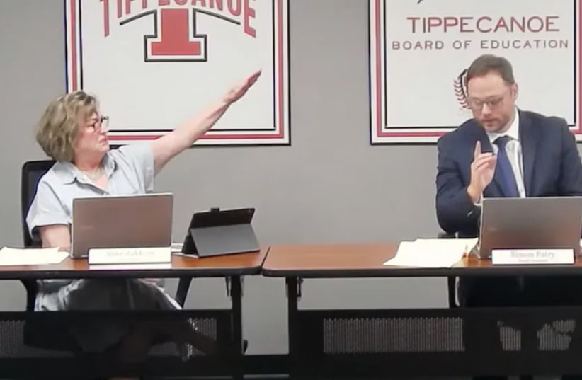  Tipp City Board of Education member Anne Zakkour delivers a Nazi salute and utters "Sieg Heil" at board then-president Simon Patry during a public meeting, Sept. 5, 2023. (photo credit: Screenshot via Tipp City Board of Education)