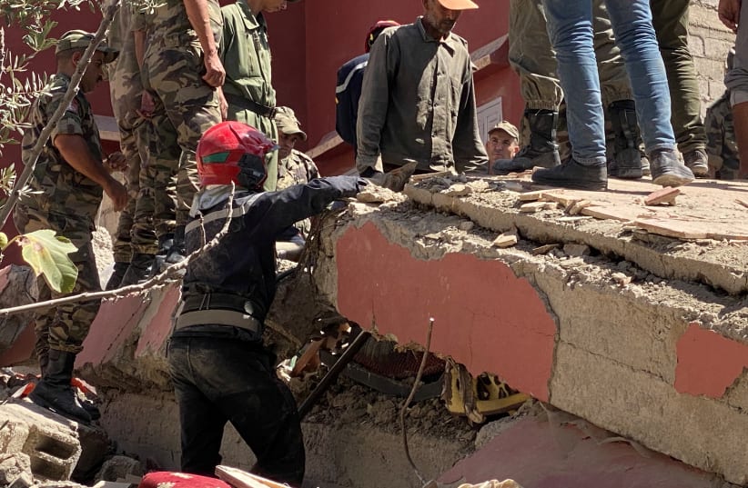  Rescuers carry a search operation following a powerful earthquake, in Amizmiz, in Morocco, September 9, 2023.  (photo credit: REUTERS/Abdelhak Balhaki)