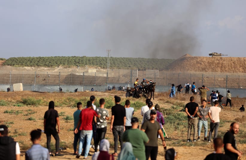  Palestinian demonstrators clash with Israeli soldiers at the Israel-Gaza border fence, east of Gaza City September 13, 2023. (photo credit: ATIA MOHAMMED/FLASH90)