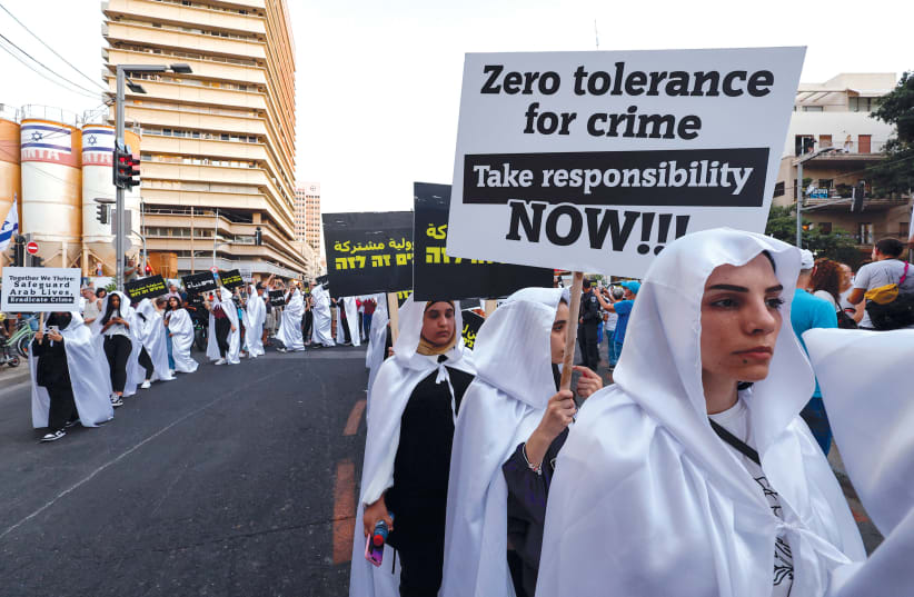  Arab Israelis stage a mock funeral in Tel Aviv on August 6 to demonstrate against what they say is the government’s failure to address soaring levels of organized crime.  (photo credit: AMMAR AWAD/REUTERS)