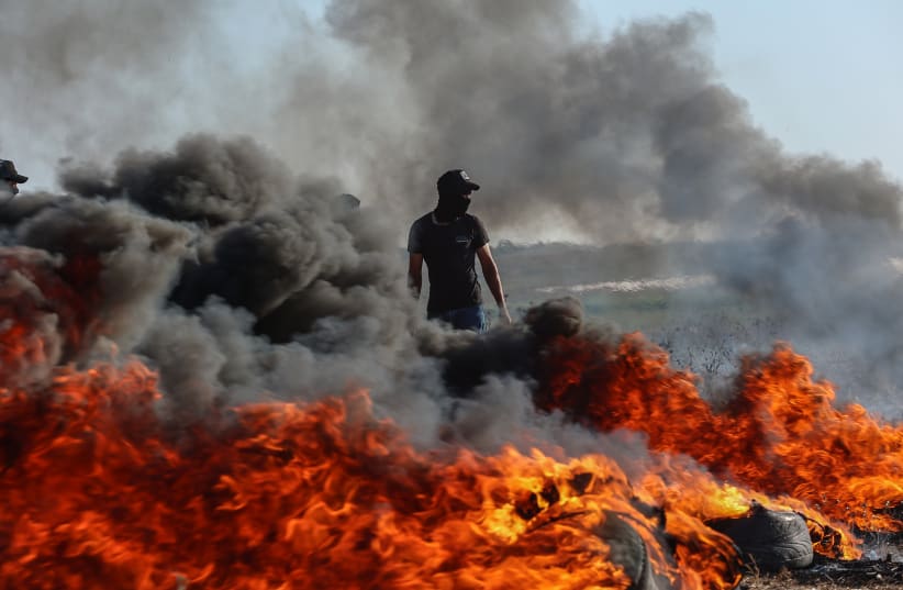  Palestinian protesters gather during a demonstration along the border fence with Israel, east of Gaza City, on September 18, 2023. (photo credit: ATIA MOHAMMED/FLASH90)